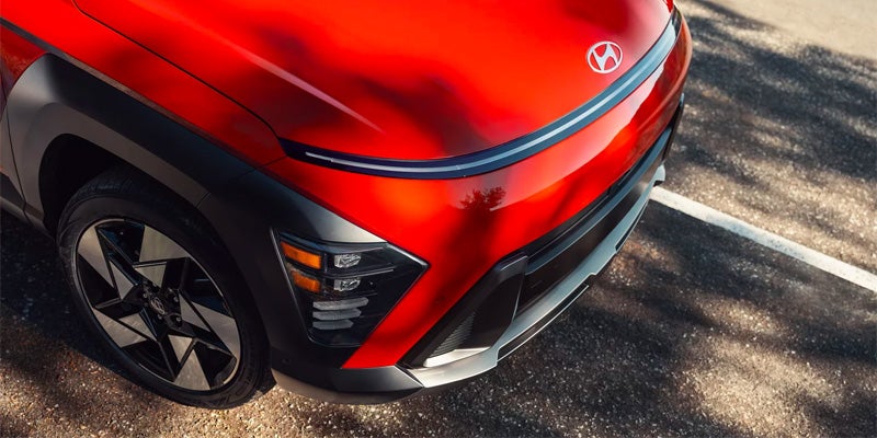 Front quarter view of a partially visible red Hyundai Kona N with black accents.